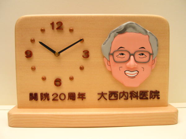 開院２０周年記念の記念品「似顔絵・医院名」入りの置き時計です。