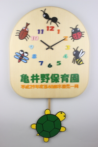 「クラス名のイラストと園名の亀を再現した大きい振り子時計」の詳細ページへ